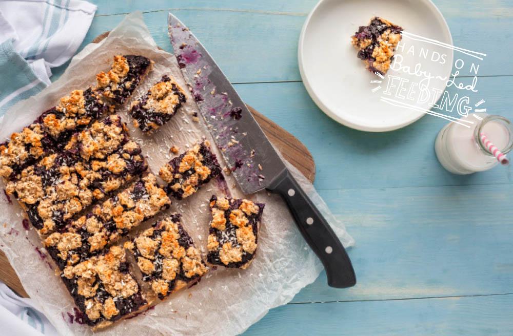 Refined sugar free healthy breakfast bars are loaded with blueberries, whole grains, and omega3 rich chia seeds! This easy recipe uses maple syrup and bananas for sweetness to save your kids from sugar overload. The texture and sweetness make these oat bars wonderful for baby led weaning. #oatbars #healthybreakfast #haelthysnacks #babyledweaning #fingerfood #babyledfeeding