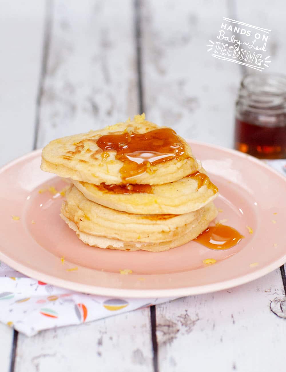 Zesty lemon and sweet maple syrup are the perfect combination in this super easy healthy baby led weaning pancake! This refined sugar free finger food can be made ahead and frozen for a quick breakfast idea on busy days. #pancakes #babyledweaning #pancakerecipe #breakfastrecipe #fingerfood #freezerfood