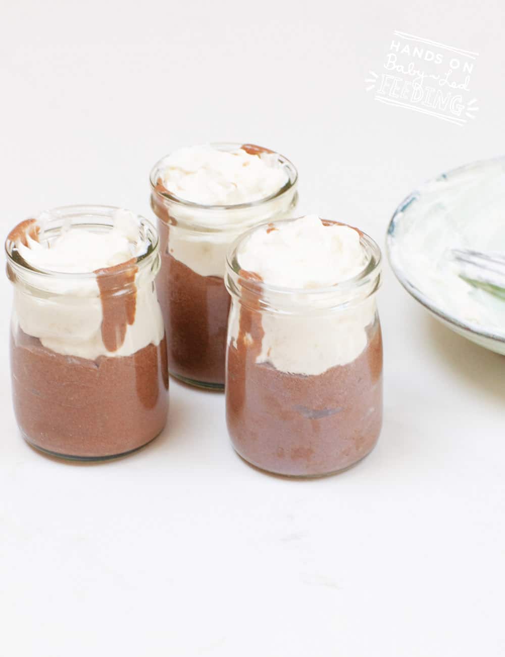 jars filled with chocolate mousse and yogurt 