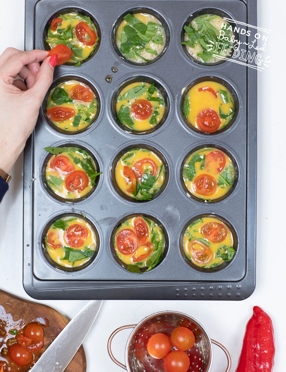 uncooked egg muffin ingredients in a muffin tin
