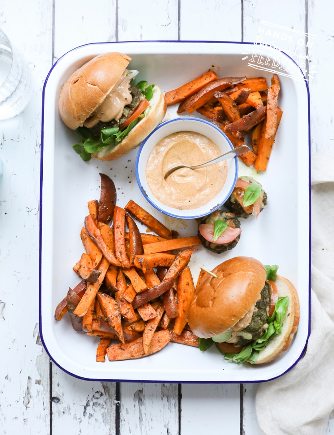 Veggie Loaded Baby Burgers with Cajun Sauce. This little burger is like an entire salad cooked into a slider sized burger! Served with a zesty (not spicy) yogurt based Cajun sauce and crispy-sweet sweet potato fries. #babyledweaning #sliders #bbq #healthyrecipe