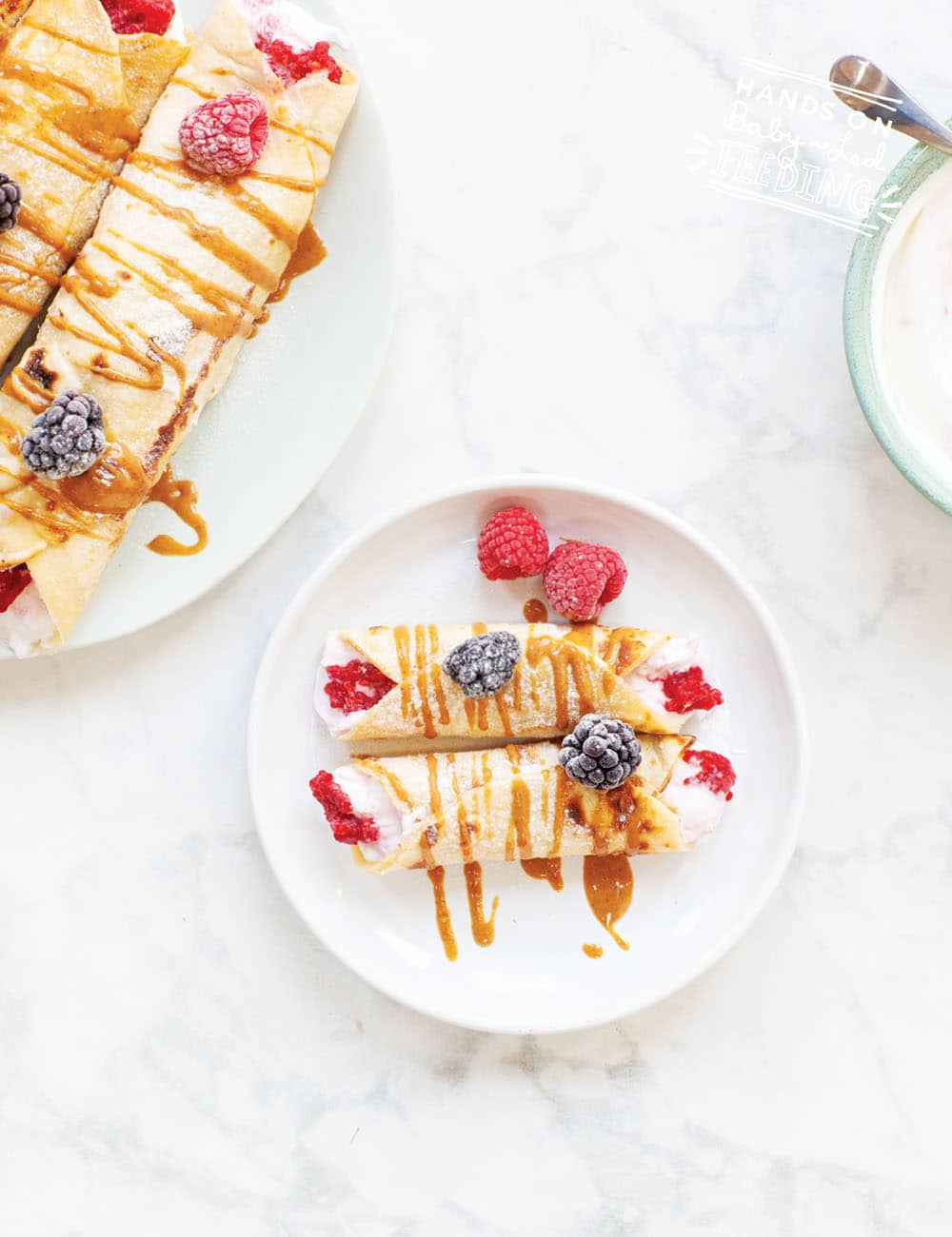 Ideas for baby breakfast! Pancake Tuesday Berry Yoghurt Baby Crepes! Sweetened naturally with fruit and wrapped in a SUPER easy crepe recipe with only 3 ingredients! Refined sugar-free breakfast or treat for babies. #babyledfeeding #babyledweaning #babybreakfast #babybreakfastideas #crepes #pancaketuesday